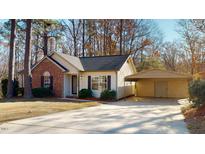 Brick ranch home with carport and landscaped yard at 1313 First Pointe, Sanford, NC 27332