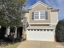 Two-story house with beige siding, white garage door, and landscaping at 112 Ryder Cup Cir, Raleigh, NC 27603