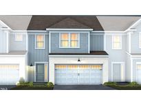 Two-story townhome with gray siding, white trim, and a two-car garage at 283 Broomside Ave, Raleigh, NC 27603