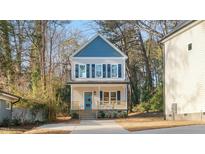 Two-story house with blue and beige siding, light blue door, and front porch at 1917 A Essex, Durham, NC 27704