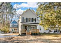 Two-story house with front porch, and landscaped yard at 1917 B Essex Rd, Durham, NC 27704