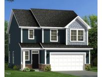 Two story home with dark blue siding and white garage door at 202 Steel Springs Ln # 47, Angier, NC 27501