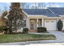 Gray two-story home with white garage door and landscaping at 5503 Rutherford Close, Pittsboro, NC 27312