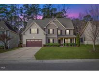 Two-story house with brown accents and a landscaped lawn at 8916 Buffalo Gourd Ln, Angier, NC 27501