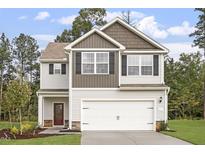 Two-story house with neutral siding, brown accents, and a two-car garage at 900 Rhino Bnd, Oxford, NC 27565