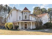 Elegant two-story home with stone accents and a charming front porch at 105 Kingfisher Way, Louisburg, NC 27549