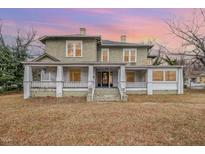 Two-story house with wrap-around porch and mature trees at 603 W Davis St, Burlington, NC 27215