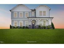 Two-story house with gray siding, stone accents, and a large front yard at 1817 Ballard Rd # Selma English Country, Fuquay Varina, NC 27526