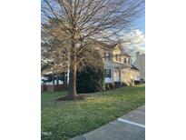 Two-story house with white siding, landscaping, and a large tree in the front yard at 4904 Arbor Chase Dr, Raleigh, NC 27616