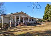 Ranch style home with front porch and landscaped yard at 805 Worth Hinton Rd, Zebulon, NC 27597