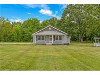 Charming ranch home with a metal roof and spacious yard at 1152 Pagetown Rd, Elon, NC 27244