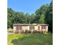 Single-story home with red accents and a spacious yard at 7055 Old Plantation Dr, Graham, NC 27253