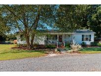 White mobile home with front porch and landscaping at 4941 Rumley Rd, Graham, NC 27253