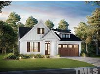 Charming farmhouse exterior with a brown garage door at 13301 Nc 27 Hwy # 3, Broadway, NC 27505