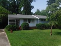 Ranch-style home with a well-maintained lawn and landscaping at 3418 Leonard St, Raleigh, NC 27607