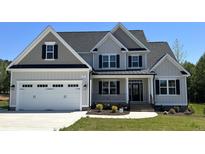 Two-story home with grey siding, white garage door and landscaping at 43 Walnut Hall Ct, Selma, NC 27576