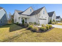 Craftsman style home with white siding, two-car garage, and landscaped front yard at 2269 Abbeyhill Dr # 133, Raleigh, NC 27610