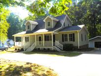 House exterior featuring a front porch and landscaping at 2486 Derby Dr, Rocky Mount, NC 27804