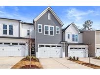 Gray and white townhouses with two-car garages and landscaping at 8950 Kennebec Crossing Dr # 81, Angier, NC 27501