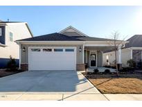 Single-story home with a two-car garage and landscaping at 108 Swain St, Clayton, NC 27527