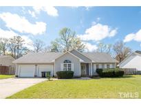 Ranch style home with a two-car garage and well-maintained lawn at 60 Rock Harbor Ln, Spring Lake, NC 28390