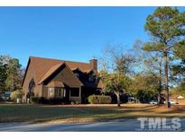 Two story house exterior with brown siding and landscaping at 15 Montana Ln, Spring Lake, NC 28390