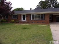 Brick ranch home with large windows and lawn at 1503 Fairview St, Dunn, NC 28334
