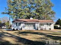 Ranch home with a well-maintained lawn at 1210 Guy Ave, Dunn, NC 28334