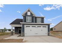 Two-story home with gray siding, white trim, and a two-car garage at 109 Hillwood Dr, Sanford, NC 27332