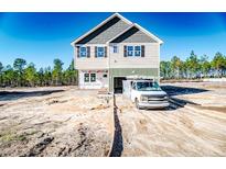 New construction home with attached garage and sandy yard at 533 Stadium Dr, Cameron, NC 28326