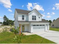 Two story farmhouse style home with a two car garage at 147 Hillwood Dr, Sanford, NC 27332