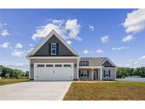 Single-story house with a two-car garage and nice lawn at 50 Oleander Ln, Sanford, NC 27332
