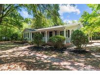 Charming ranch home with covered porch and brick walkway at 521 S Main St, Broadway, NC 27505