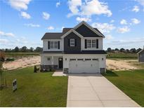 Two-story house with gray and white siding, and a two-car garage at 114 Hillwood Dr, Sanford, NC 27332