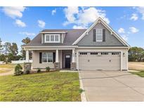 Newly constructed home with gray siding, beige accents, and a two-car garage at 127 Hillwood Dr, Sanford, NC 27332