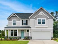 Two-story house with gray and white siding, stone accents, and a light blue door at 42 Waverly (Lot 404) Way, Cameron, NC 28326