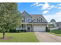 Two story house with gray siding and stone accents at 157 Regimental Dr, Cameron, NC 28326