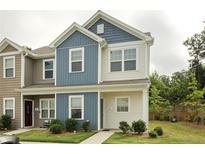 Two-story townhome with blue and beige siding at 100 Chandler Ct, Sanford, NC 27330