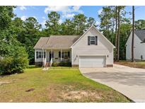 Beige house with a garage and landscaped yard at 240 Captain Hbr, Sanford, NC 27332