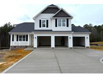 Two-story house with three-car garage and concrete driveway at 736 Burley Oak Dr, Cameron, NC 28326