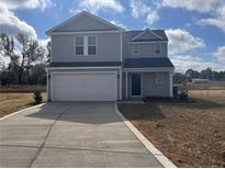 Two-story home with gray siding, white garage door, and landscaping at 59 Marley (Lot 13) Way, Dunn, NC 28334