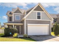 Two-story house with gray siding and a two-car garage at 47 New London Hbr, Cameron, NC 28326