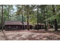 Rustic wooden house with a large yard and mature trees at 555 Key Rd Rd, Sanford, NC 27332