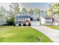 Two-story brick house with a three-car garage at 3375 Carolina Way, Sanford, NC 27332