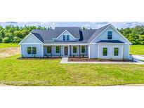 One-story farmhouse with gray siding, front porch, and large yard at 355 Graham Rd, Cameron, NC 28326