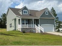 Two-story house with gray siding and stone accents at 241 Bunting Dr, Lillington, NC 27546