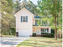 Two-story house with attached garage and landscaped yard at 82 Stonecliff Ln, Sanford, NC 27332