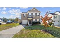 Two story house with a brown exterior and landscaping at 159 Scranton Ct, Cameron, NC 28326