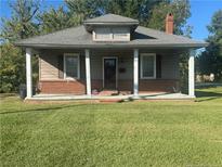 Small house with a covered porch and brick foundation at 100 W C St, Erwin, NC 28339