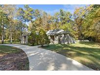 Stone house exterior with driveway and landscaping at 912 Botany Woods Dr, Sanford, NC 27330